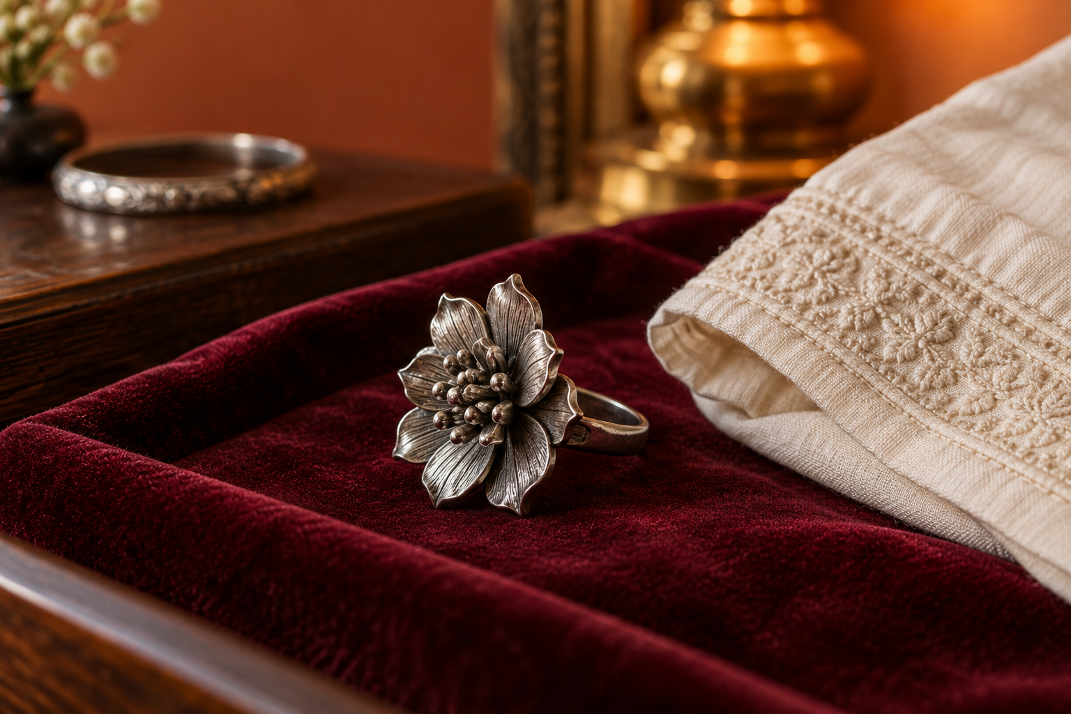Floral statement ring on a burgundy jewellery tray.